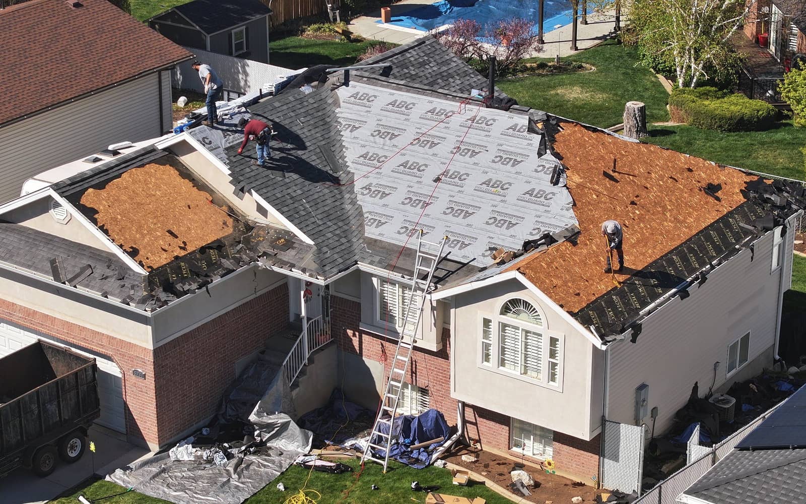 NuRoof crew tearing off and replacing an asphalt shingle roof on a Utah home